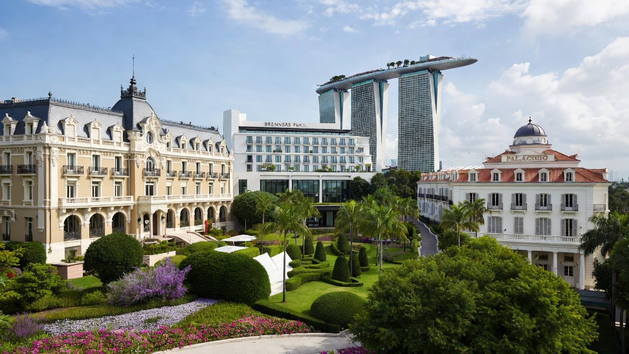 Belle Époque hotel facades above landscaped gardens, with modern towers rising behind